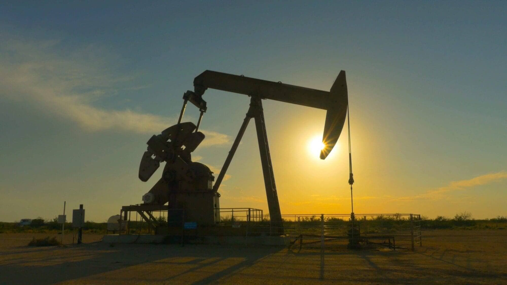 A Texas oil pump jack silhouetted against the sunset.