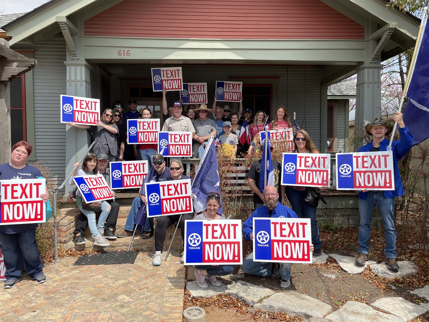 Texans holding signs at a rally.