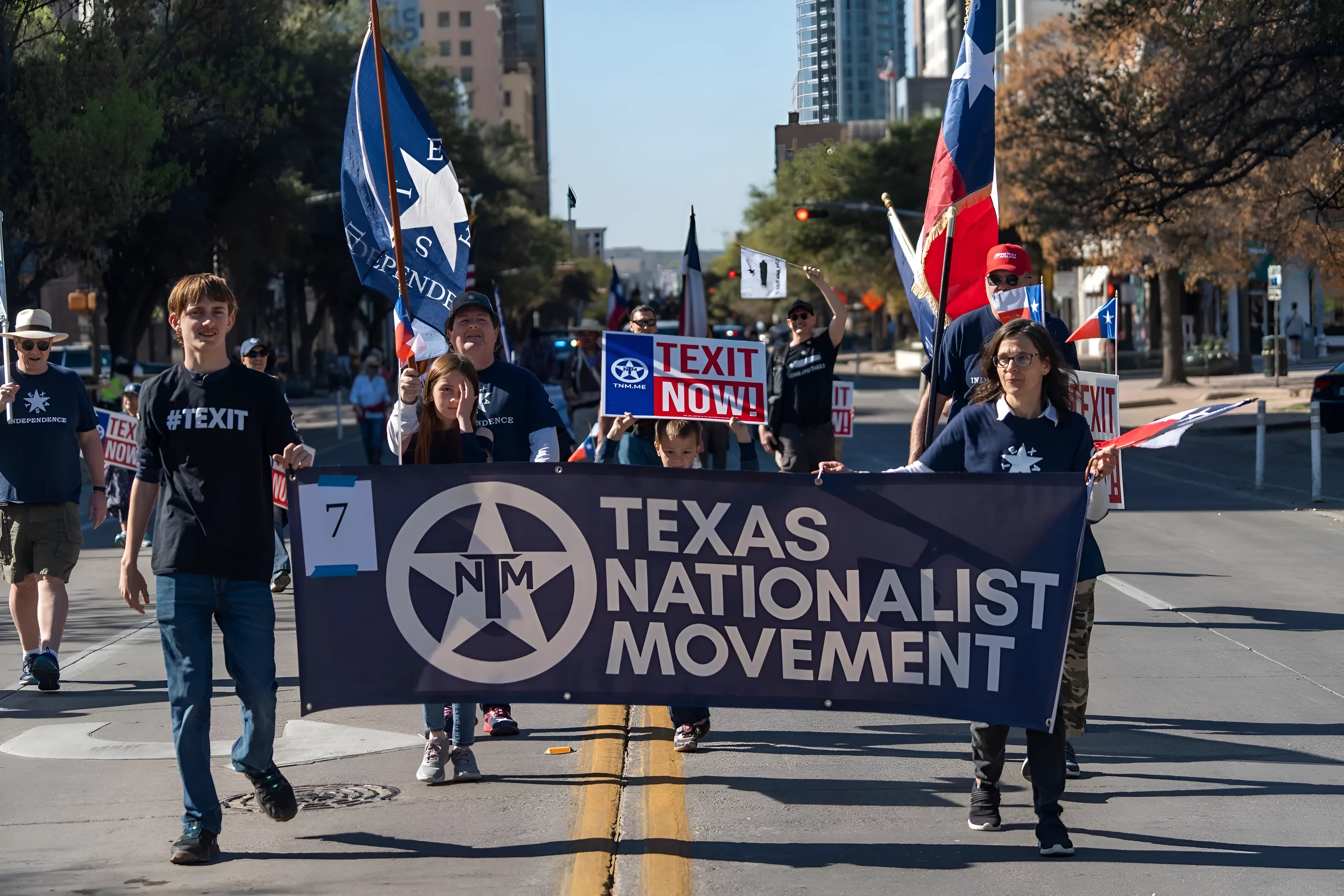 Texans marching together through a city street.